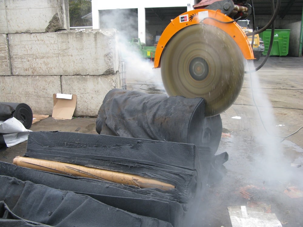 Cutting rolls of carpet Excavator saws cut through rolled materials such as tough car-carpet, with ease, reducing rolls to sheets