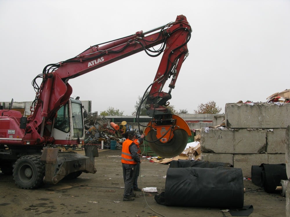 Cutting carpet rolls with Echidna D4HS diamond rocksaw on 17 tonne wheeled excavator