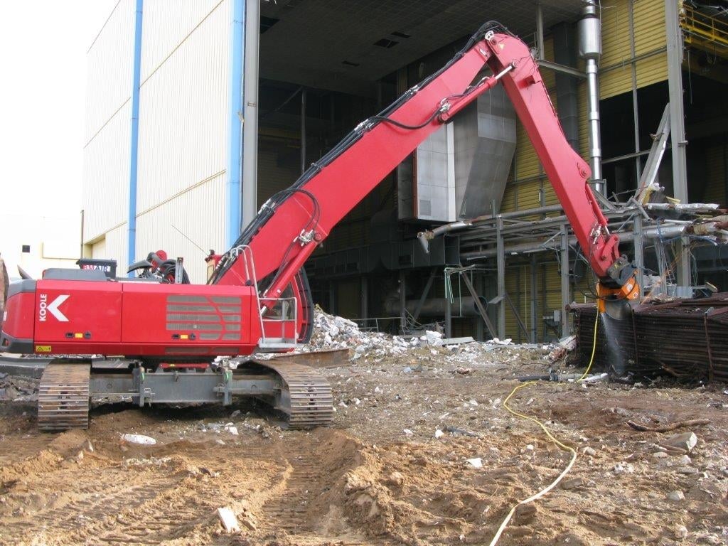 Excavator cutting steel pipes